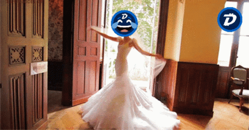 A Woman In A Wedding Dress Has A Smiley Face On Her Head With The Letter D On It GIF