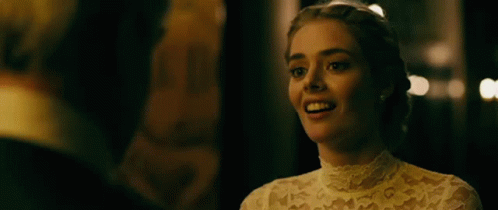 A Woman In A Wedding Dress Is Laughing With A Man In A Tuxedo . GIF