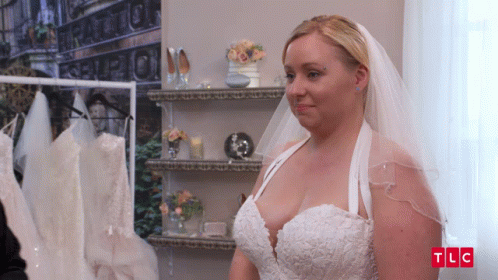 A Woman In A Wedding Dress With The Letters Tlc On The Bottom Left GIF