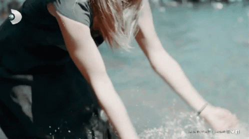 A Woman In A Wetsuit Is Reaching Into The Water With A Linkedin Logo In The Background GIF
