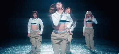 A Woman In A White Calvin Klein Shirt Is Dancing With Other Women GIF