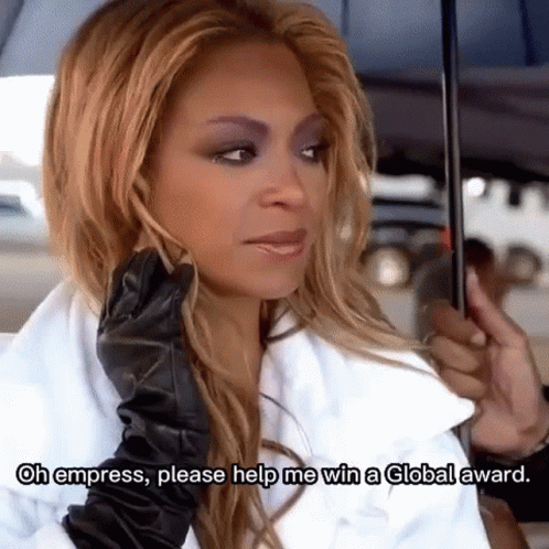 A Woman In A White Coat And Black Gloves Is Holding An Umbrella . GIF
