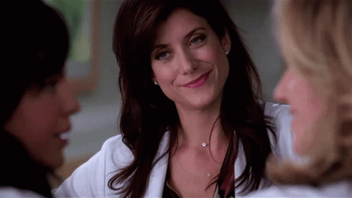 Woman Smiling And Talking In White Coat GIF