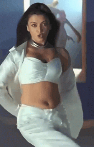 A Woman In A White Crop Top And White Pants GIF