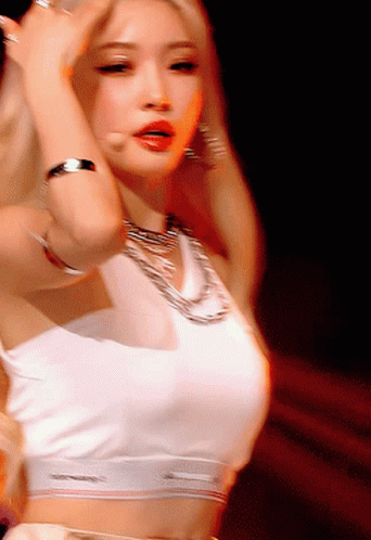 A Woman In A White Crop Top Is Dancing GIF