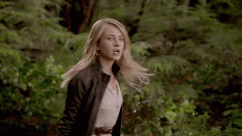 Woman In White Dress And Black Jacket In Woods GIF