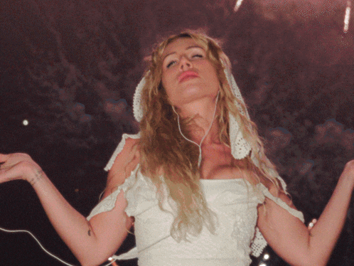 A Woman In A White Dress Has A Tattoo On Her Wrist That Says ' I Love You ' On It GIF
