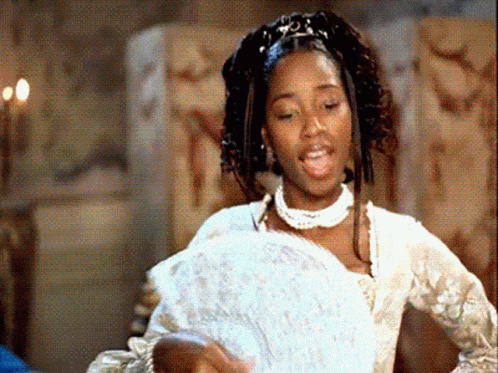 A Woman In A White Dress Holding A Fan GIF