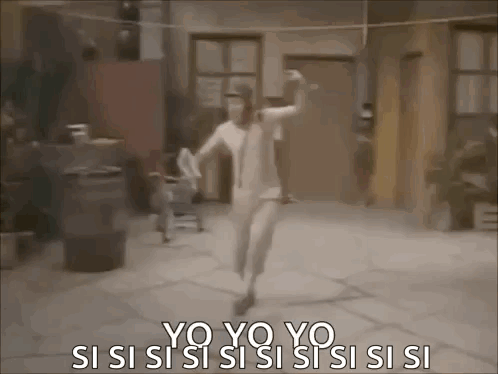 a woman in a white dress is dancing in front of a building .