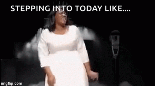 A Woman In A White Dress Is Dancing On A Stage In Front Of A Microphone With The Words Stepping Into Today Like . GIF