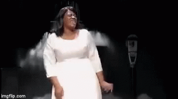 A Woman In A White Dress Is Dancing On A Stage With The Words `` I Made It '' Written Below Her . GIF
