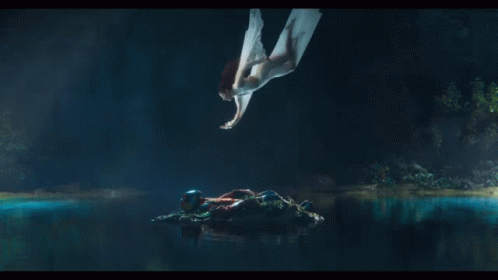 A Woman In A White Dress Is Flying Through The Air GIF