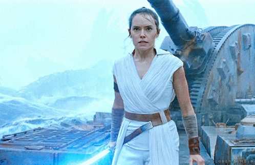 A Woman In A White Dress Is Holding A Light Saber In Her Hand GIF