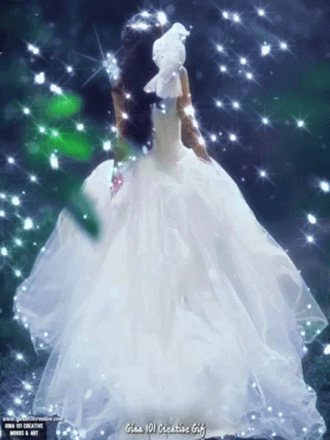 A Woman In A White Dress Is Holding A White Bird On Her Head GIF