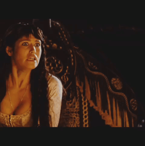 A Woman In A White Dress Is Reaching Out Towards A Man In A Black Shirt GIF