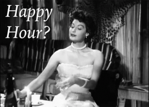 A Woman In A White Dress Is Sitting At A Table With The Words Happy Hour Above Her GIF