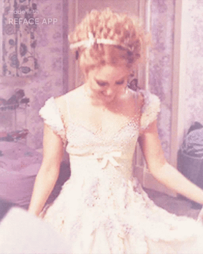 A Woman In A White Dress Is Smiling With The Words Made With Reface App Below Her GIF