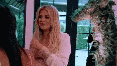 A Woman In A White Dress Is Standing Next To A Woman In A Black Dress . GIF