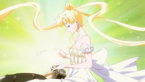 A Woman In A White Dress Is Touching A Man 'S Face GIF