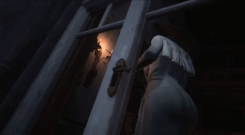 A Woman In A White Dress Stands In A Dark Room GIF