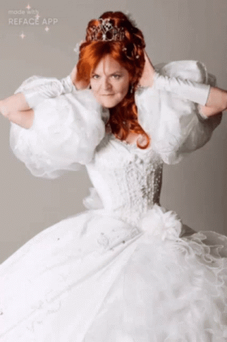 A Woman In A White Dress With A Tiara On Her Head Is Made With The Reface App GIF