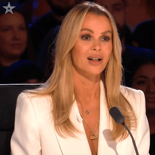 Woman In White Jacket Speaking Into Microphone With Star GIF