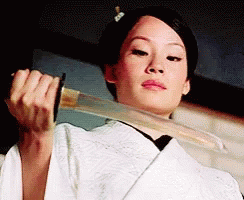A Woman In A White Kimono Is Holding A Large Sword In Her Hands . GIF
