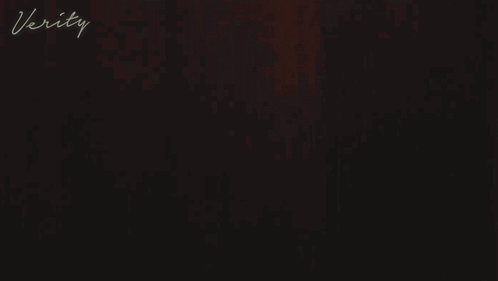 A Woman In A White Robe With The Word Verity On The Bottom Right GIF