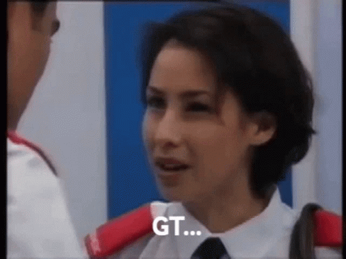 A Woman In A White Shirt And Tie Is Talking To A Man In A White Shirt And Tie . GIF