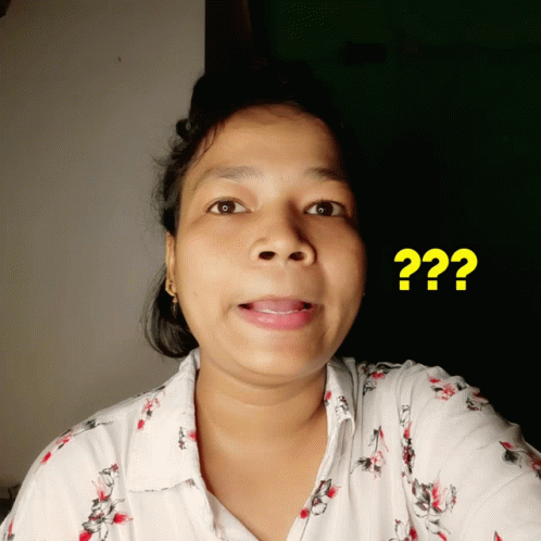a woman in a white shirt has a yellow question mark above her head