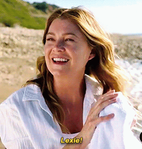 A Woman In A White Shirt Is Laughing And Says Lexie GIF