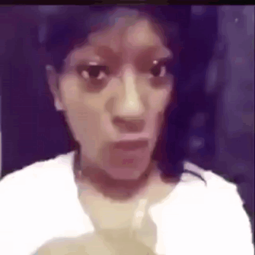 A Woman In A White Shirt Is Making A Funny Face In A Blurry Photo . GIF