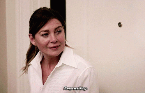 A Woman In A White Shirt Is Saying " Keep Walking " GIF