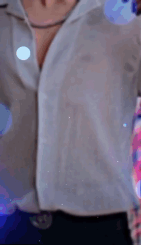 A Woman In A White Shirt Is Standing In Front Of A Sign That Says Tequila N6 GIF
