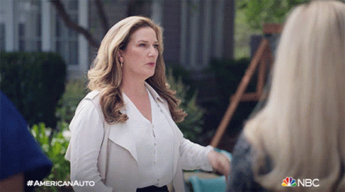 Woman In White Talking To Woman With NBC Logo GIF