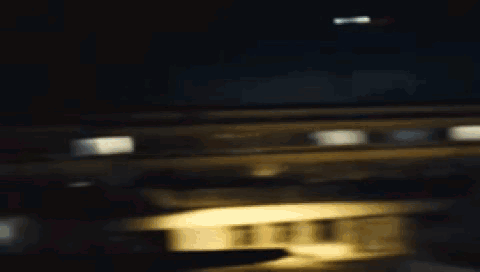 A Woman In A White Shirt With A Hole In It Is Standing In A Dark Room . GIF