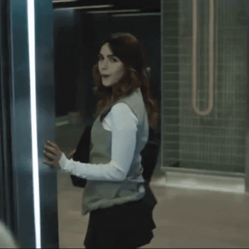 A Woman In A White Suit Is Standing In An Elevator And Says Thank You Mommy GIF