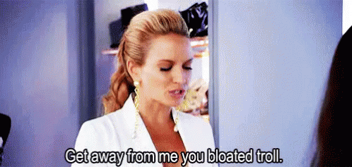 A Woman In A White Suit Is Talking To Another Woman In A Closet And Says Get Away From Me You Bloated Troll . GIF