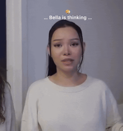 A Woman In A White Sweater With The Words Bella Is Thinking Behind Her GIF