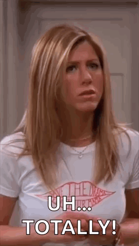 A Woman In A White T-Shirt Is Standing In Front Of A Door And Saying `` Uh ... Totally ! '' GIF