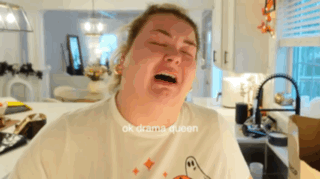 A Woman In A White T-Shirt With A Ghost On It Is Crying GIF