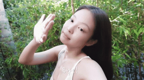 A Woman In A White Tank Top Is Covering Her Face With Her Hand And The Words Bye Written On The Bottom GIF