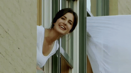 Woman Smiling Looking Out Window GIF