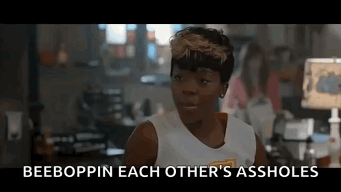 A Woman In A White Tank Top Is Talking To Another Woman In A Room In A Movie . GIF