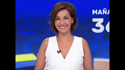 a woman in a white top is smiling in front of a blue background with the number 30