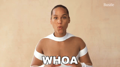 A Woman In A White Top With The Word Whoa On Her Chest GIF