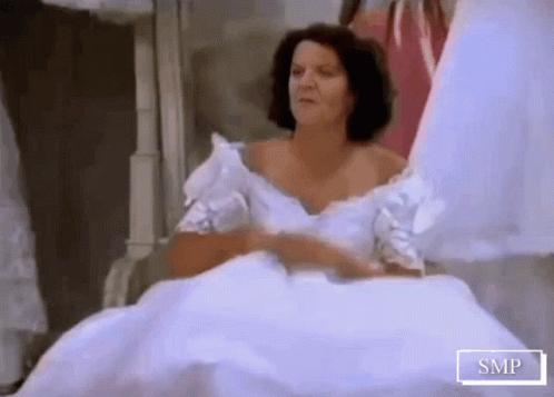 A Woman In A White Wedding Dress With Smp Written On The Bottom Of The Image GIF