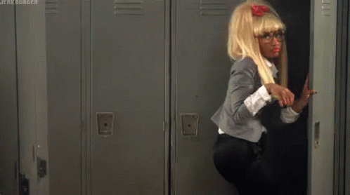 A Woman In A Wig And Glasses Is Standing In A Locker With The Words Jerk Burger On The Bottom Right GIF