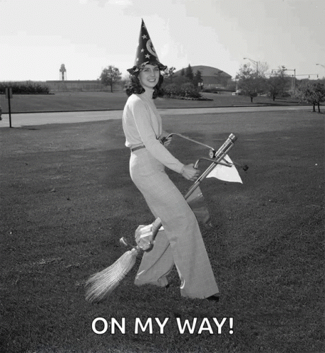 a woman in a witch hat is flying on a broom with the words on my way written below her