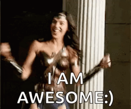 A Woman In A Wonder Woman Costume Is Dancing In Front Of A Pillar And Saying `` I Am Awesome '' . GIF